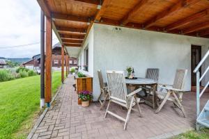 a patio with a table and chairs on a brick patio at Ferienwohnung Käppeleblick in Bernau im Schwarzwald