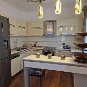 a large kitchen with white cabinets and a counter top at Villa Pearl Adriatic Coast in Golem