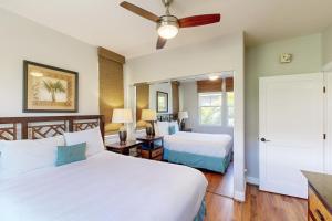 a bedroom with two beds and a ceiling fan at Halii Kai 18E - Waikoloa in Waikoloa +32 photos