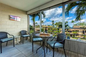 a patio with chairs and a table with a view at Kamaole Beach Royale 208 in Kihei