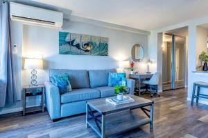 a living room with a couch and a table at Kamaole Beach Royale 208 in Kihei