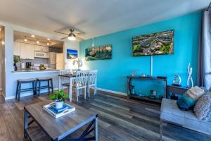 a living room with a couch and a table at Kamaole Beach Royale 208 in Kihei