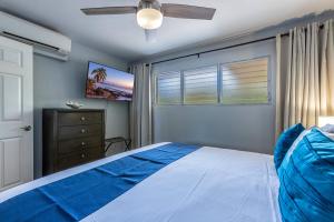 a bedroom with a bed and a ceiling fan at Kamaole Beach Royale 208 in Kihei