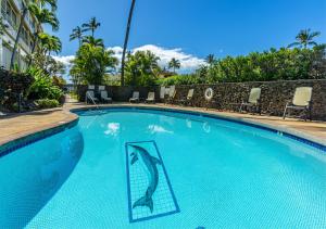 a swimming pool with a dolphin stencil on it at Kamaole Beach Royale 208 in Kihei
