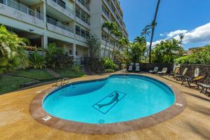 a swimming pool in front of a building at Kamaole Beach Royale 208 in Kihei