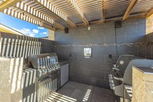 a patio with a barbecue grill and a grill at Kamaole Beach Royale 208 in Kihei