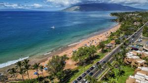 an aerial view of a beach with a boat in the water at Kamaole Beach Royale 208 in Kihei