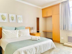 a bedroom with a large white bed and a window at LA Diamond Lodge & Safari in Lime Acres