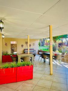 a room with a table and chairs under a tent at LA Diamond Lodge & Safari in Lime Acres