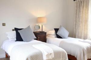 two beds sitting next to each other in a room at Luxury Pet-Friendly Retreat with Private Hot Tub in Boardmills +5 photos