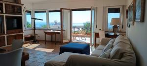 a living room with a couch and a balcony at VelaLatina Residence B&B Soverato - Camera Maestrale & Camera Tramontana in Soverato Marina