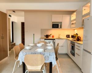 a kitchen and dining room with a table and chairs at Harmónia Vendégház, klíma, kerékpáros barát szálláshely in Bükkszék
