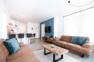 a living room with two brown couches and a table at Paddel Nr 5 in Neustadt in Holstein