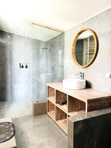 a bathroom with a sink and a mirror and a shower at The volcano in Kubupenlokan