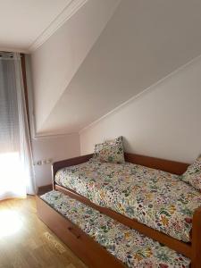 un dormitorio con una cama y una ventana en Ático, en A Guarda