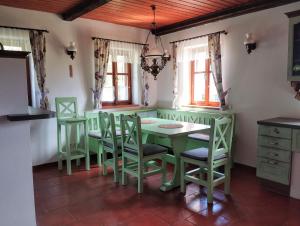 a dining room with a table and chairs at Cottage Kolné in Stvolínky