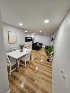 a dining room and living room with a table and chairs at Pretas Village Flats in Funchal