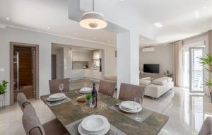 a dining room and living room with a table and chairs at Lovely Home In Barbariga With Wifi in Barbariga