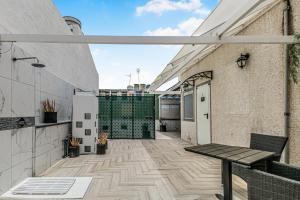 a balcony with a wooden table on a building at Urban Rooms San Roque with Solarium in Las Palmas de Gran Canaria