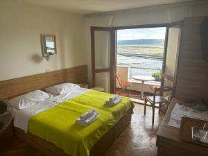 a bedroom with a bed and a balcony with a view at Rooms and Apartments Roza in Portorož