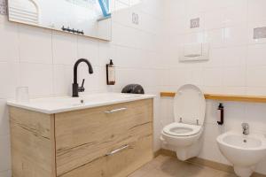 a bathroom with a toilet and a sink at Hotel BluMarine in Roseto degli Abruzzi