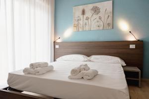 two towels on a bed with two pillows at Hotel BluMarine in Roseto degli Abruzzi