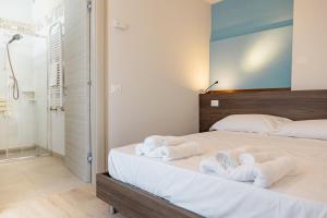 a bedroom with a bed with towels on it at Hotel BluMarine in Roseto degli Abruzzi