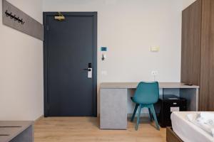 a blue chair sitting at a desk in a room at Hotel BluMarine in Roseto degli Abruzzi