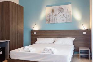 a bedroom with a bed with two towels on it at Hotel BluMarine in Roseto degli Abruzzi
