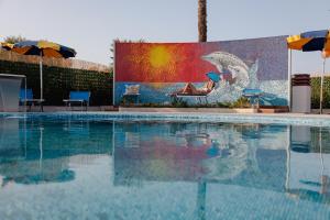 a swimming pool with a mural of a bird at Hotel BluMarine in Roseto degli Abruzzi