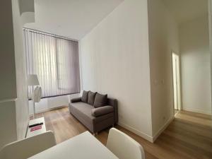 a living room with a couch and a table at Joli T2 en plein centre-ville de Lyon in Lyon