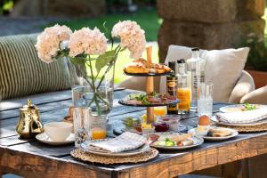 a table with plates of food and flowers on it at Mas Sant Marc in Puigcerdà +16 photos