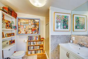 a bathroom with a toilet and a sink and a book shelf at Vibrant Home with Patio - Near Santa Monica Pier! in Los Angeles +31 photos