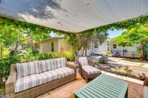a patio with a couch and a chair and a table at Vibrant Home with Patio - Near Santa Monica Pier! in Los Angeles