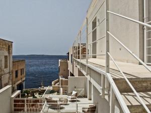 a balcony of a building with a view of the water at Fenici Levanzo - Island Apartments in Levanzo