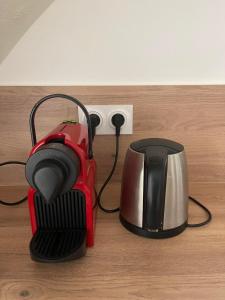 a tea pot and kettle next to an electrical outlet at L'échappée belle in Le Pouget