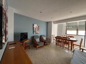 a living room with a table and a dining room at Prado in Peniscola