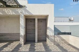 two garage doors on the side of a building at Gorgeous 2 Bed Apt in Al Warqa in Dubai