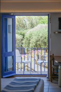 an open door to a balcony with chairs on it at Hotel Blaumar Cadaqués by Fimedhotels in Cadaqués