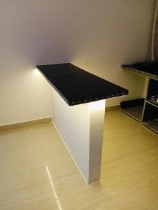a table with a black counter in a room at Malaiya Homestay - Grandeur Living Experience in Jabalpur +56 photos