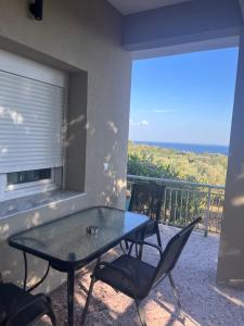 a patio with a table and chairs on a balcony at Liostasi Hοuse in Makri