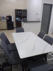a conference room with a white table and chairs at Suriati&Fhaiz Homestay in Sungai Petani
