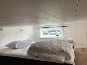 a large bed in a bedroom with a window at Hultatorpet in Tvååker