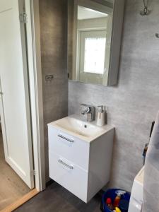 a bathroom with a sink and a mirror at Hultatorpet in Tvååker