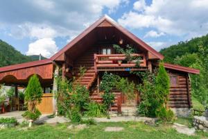 a log home with a gambrel roof at Plav Riverside Village in Plav
