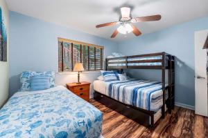 a bedroom with a bed and a ceiling fan at Honu O Kai Turtle Of The Sea in Kailua-Kona +41 photos
