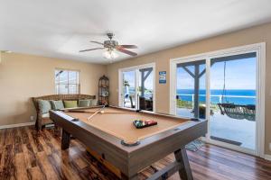 a pool table in a living room with a ceiling fan at Honu O Kai Turtle Of The Sea in Kailua-Kona