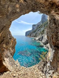 a view of the ocean through a cave at Casa M&M in Cala Gonone