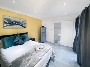a bedroom with a bed with a teddy bear on it at BOSTON HOUSE in Cape Town