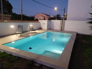 a swimming pool in a backyard at night at La Casa del Sol in La Eliana